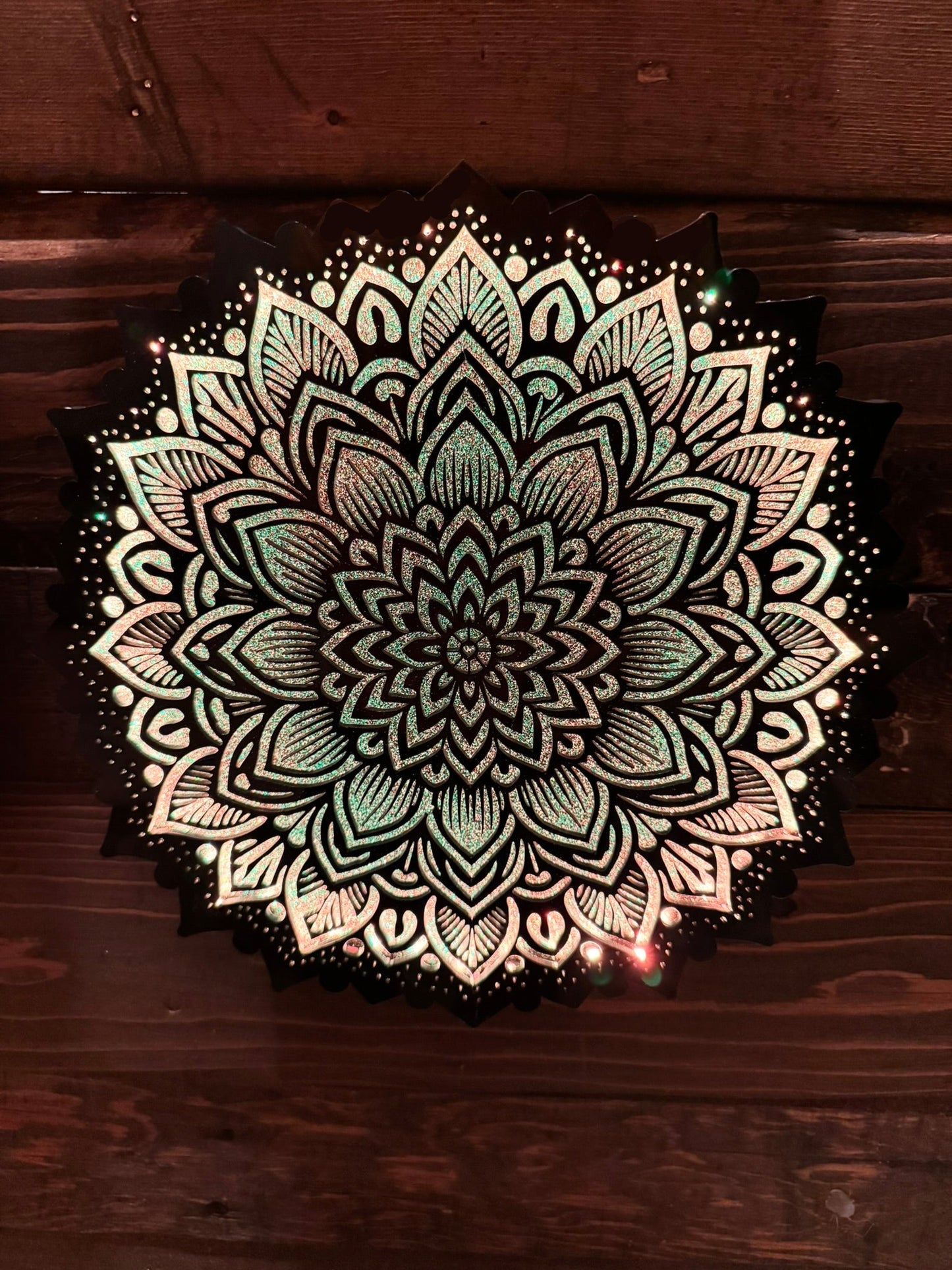 Decorative mandala design on a wooden surface