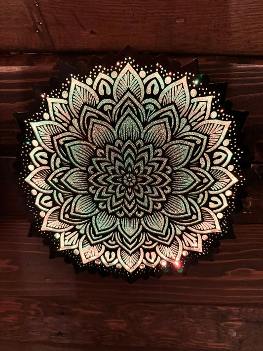 Decorative mandala design on a wooden surface