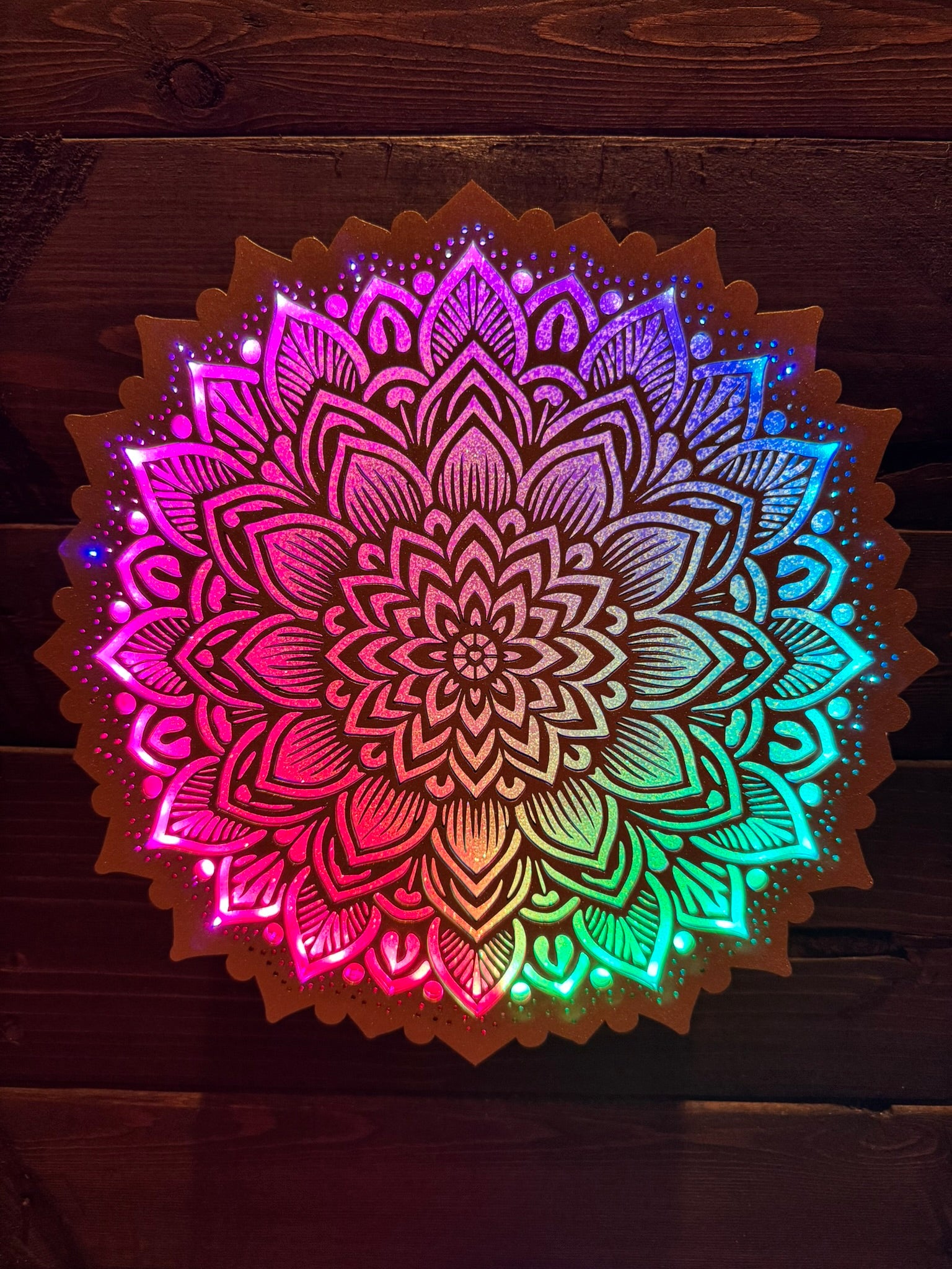 Colorful mandala design on a wooden background
